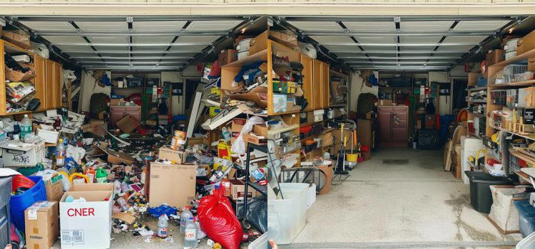 A garage split into two parts: the left side is cluttered with various items and boxes, while the right side is orderly with neatly arranged shelves and organized storage.